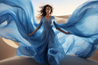 Woman in blue waving dress with flying fabric.