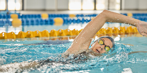 Sports, water or girl training in swimming pool for a race competition, exercise or cardio workout. Female swimmer, wellness or healthy woman exercising with fitness speed in practice or race