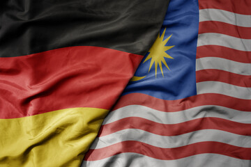 Wall Mural - big waving realistic national colorful flag of germany and national flag of malaysia .