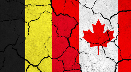 Flags of Belgium and Canada on cracked surface - politics, relationship concept