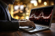 © alisluch - Businessman's hands over his laptop and virtual light graphics
