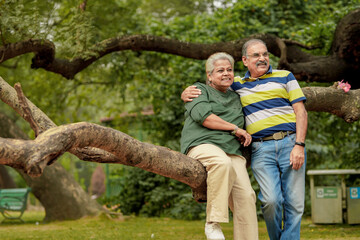 Wall Mural - happy Indian senior couple together spending time at park.