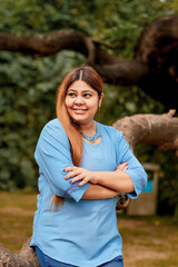 Wall Mural - young and confident Indian woman giving expression at park.