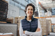 © Jacob Lund - Mature woman smiling at the camera in a logistics centre