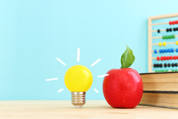 Poster - Education concept image. Creative idea and innovation. light bulb metaphor over wooden table