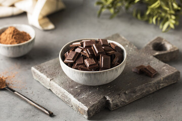 Cubes of dark artisan chocolate in a bowl. Bitter chocolate