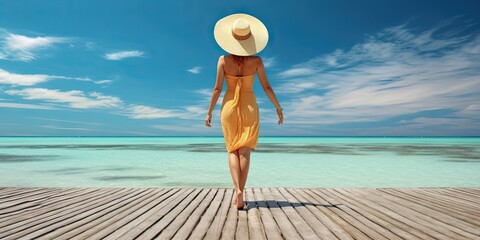 Wall Mural - Travel concept. Beautiful woman standing on beach and sea with copy space