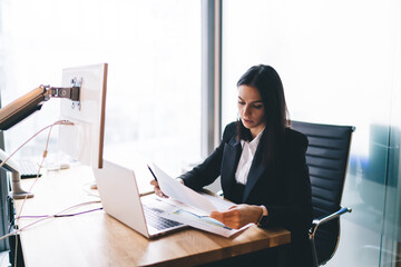 Wall Mural - Focused young woman working with documents