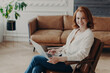 © VK Studio - Entrepreneur in luxury apartment, chats online with a colleague via video, using a laptop and free internet.