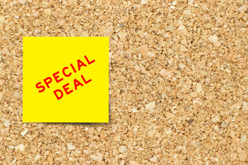 Sticker - Yellow note paper with word special deal on cork board background with copy space