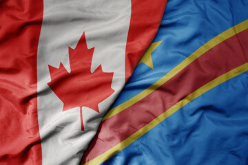 Wall Mural - big waving realistic national colorful flag of canada and national flag of democratic republic of the congo .