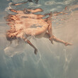 Woman in a white dress under water as if in weightlessness