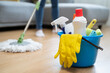 © Pormezz - happy Female housekeeper service worker mopping living room floor by mop and cleaner product to clean dust.