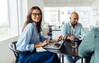 © (JLco) Julia Amaral - Mature designer sitting at a table with her colleagues