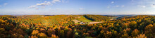Aerial Drone Panoramic View Of The Autumn Colours As The Sun Sets In The Hill Country On The Border Of Burgenland And Styria Under Scattered Clouds, Bad Loipersdorf, Styria, Austria.