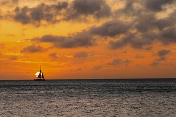 Canvas Print - a large sail boat is out in the ocean at sunset