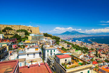 Wall Mural - Naples, Italy. View of the city from above, with the Gulf of Naples and Mount Vesuvius. On the left the Hill of San Martino with Castel Sant'Elmo. 2023-07-04.