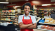 Smiling young female supermarket worker looking at the camera.