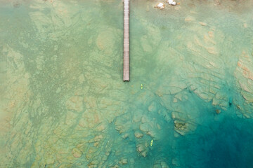 Wall Mural - aerial view of a jetty and two canoes on lake garda near sirmione