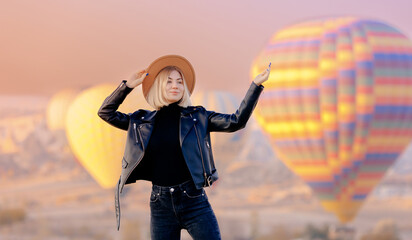 Wall Mural - Happy woman tourist in hat background hot air balloons in Cappadocia Turkey. Concept tourism travel Goreme