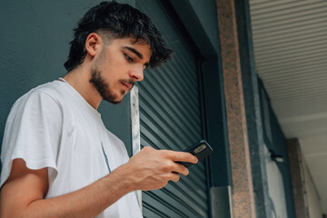 Sticker - young man in the street looking at the mobile phone