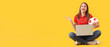 © Pixel-Shot - Happy young woman with soccer ball and laptop on yellow background with space for text