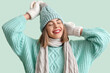 © Pixel-Shot - Frozen young woman in winter clothes on green background