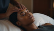 © JQM - A black woman enjoying a  head (scalp) massage at a spa,  luxurious spa, relaxation