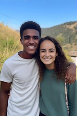 Wall Mural - Smiling mixed race young couple posing outside looking at the camera