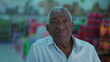 © Marco - Portrait of an elderly black Brazilian man close-up face looking at camera with neutral expression with grocery products in blurred background