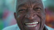 © Marco - Macro close-up of a senior Brazilian black man laughing and smiling. Charismatic friendly elderly African American facewith wide smile
