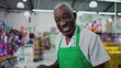 © Marco - One Black Brazilian Senior Employee of Supermarket with Tablet, Inside Grocery Store. Portrait close-up face of an African American person at workplace