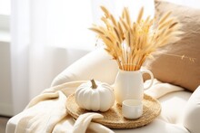 The Cozy Autumn Concept Is Captured In The Living Room Of A Home, Where You Can Find A Still Life Arrangement Of Dried Pampas Grass Placed In A Vase. Additionally, There Are White Ceramic Pumpkins, A