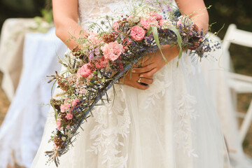 Wall Mural - The bride holds her wedding bouquet in her hands