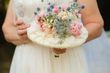 Wall Mural - The bride holds her wedding bouquet in her hands