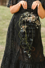 Wall Mural - The bride holds her wedding bouquet in her hands