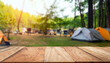 © Uuganbayar - Wooden table background of free space for your decoration and blurred background of camping in mountains.