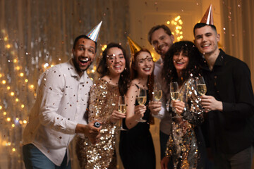 Canvas Print - Blurred view of happy friends with glasses of sparkling wine celebrating birthday indoors