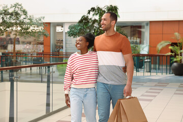 Wall Mural - Family shopping. Happy couple with purchases in mall