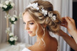 © MVProductions - Hairdresser making an elegant hairstyle styling bride with white flowers in her hair