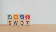 SWOT Analysis And Strategic Planning Technique Concept. SWOT Words Means Strengths, Weaknesses, Opportunities And Threats On Wooden Cube Blocks With Grunge Grey Background Including Copy Space