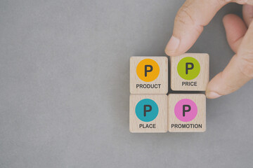4Ps, Product, Price, Place, Promotion,  text on wooden cube blocks on grunge grey background including copy space for marketing strategy concept