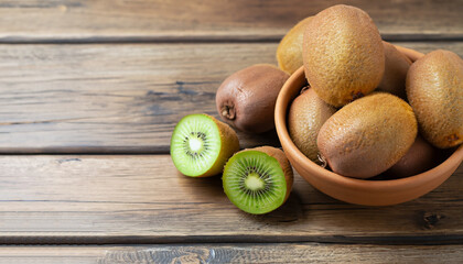 Wall Mural - Kiwi fruit in a bowl on wooden background. Copy space