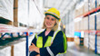 © Monster Ztudio - Young woman happy standing and looking at camera. Female warehouse worker smiley and smart confident at storehouse