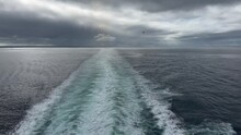 The Wake Behind A Cruise Ship In On A Cold, Cloudy, Moody Day At Sea