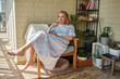 © stockmaster - a young woman in a smart dress with a glass of white wine, tasting the taste and smell of wine on the terrace of her house on a summer day
