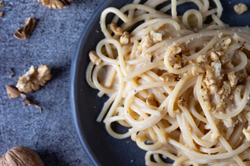 Wall Mural - Spaghetti with walnut cream. Simple, nutritious and tasty dish suitable for those who follow a vegetarian diet.