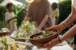 © pressmaster - Focus on hands of young woman putting wooden bowl with fresh homemade vegetable salad on table while serving it for family dinner