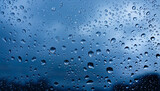 Fototapeta Natura - Water drops on a glass pane in front of dark rain clouds in blue color