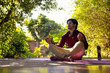 © Wavebreak Media - Focused indian man practicing yoga meditation on sunny terrace, copy space